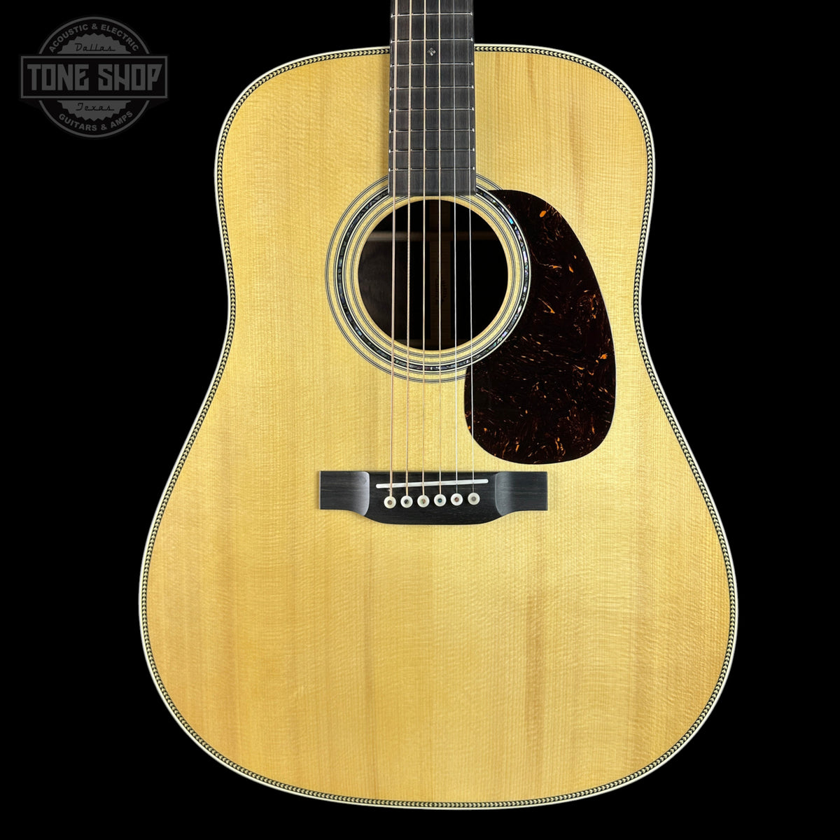 Acoustic guitar with a visible brand logo in the corner