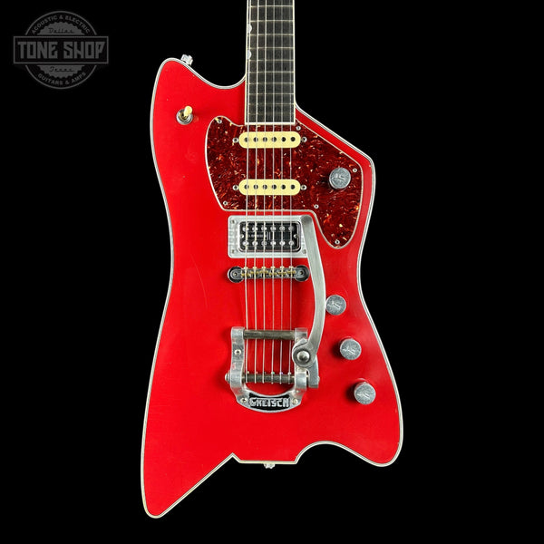 Red electric guitar with a black background, featuring the brand 'Tone Shop'.