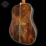 Close-up of a guitar's wooden back and sides with 'Tone Shop' logo.