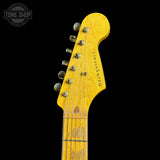 Close-up of a yellow-finish Fender Stratocaster guitar headstock with six tuning pegs and the 'Nashd guitars' brand name printed on it, set against a solid black background.