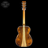 Wooden acoustic guitar on a black background with 'Tone Shop' logo.