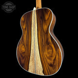 Wooden acoustic guitar with a visible brand logo in the corner