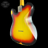 The back of a classic electric guitar with a sunburst finish showing a bright yellow center fading to orange and black around the edges, photographed against a solid black background.