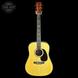 Acoustic guitar with a Tone Shop logo in the corner