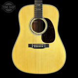Acoustic guitar with a visible brand logo on a black background