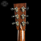 Close-up of a guitar headstock with tuning pegs on a black background, featuring 'Tone Shop' branding.