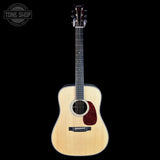 Acoustic guitar with a visible brand logo on a white background