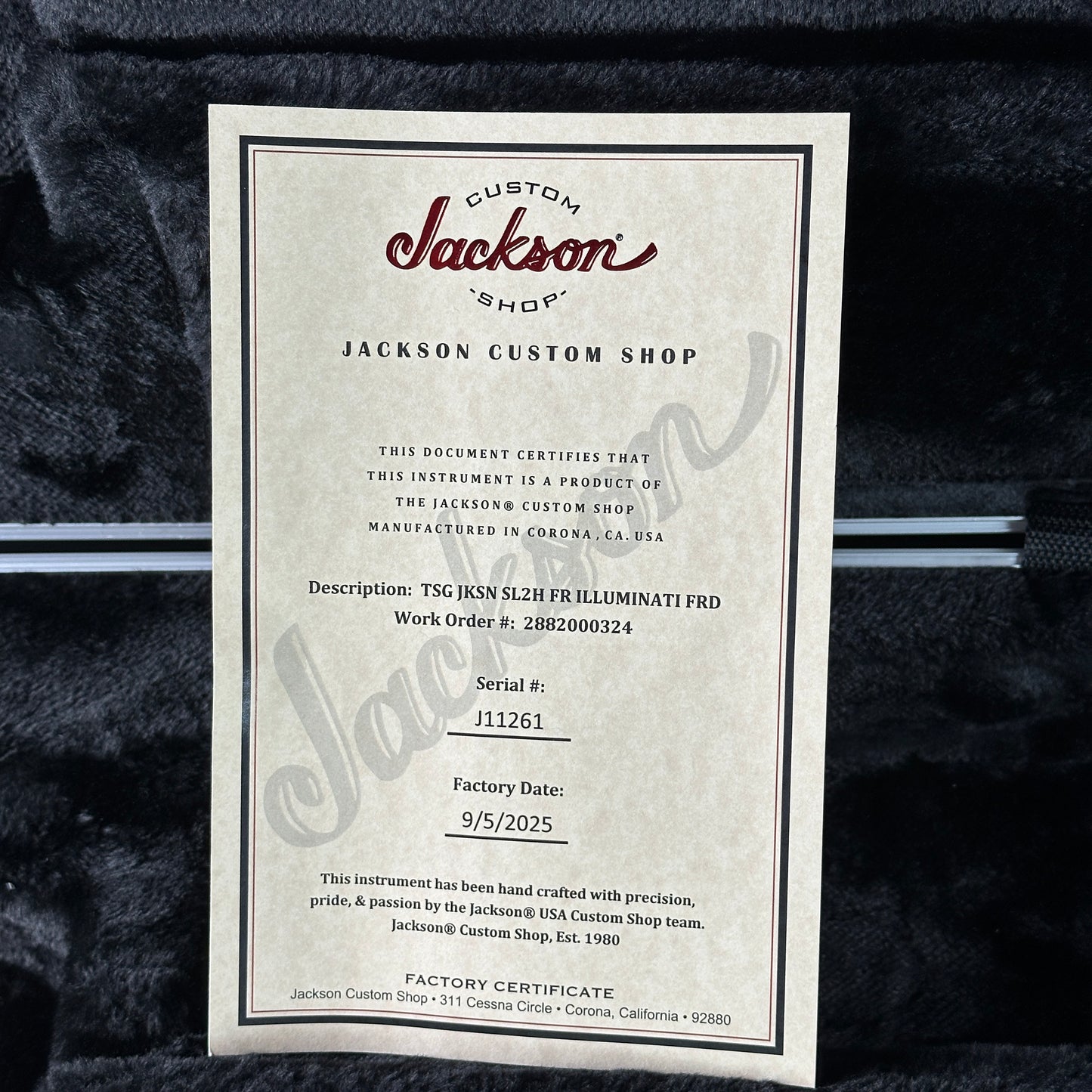 Jackson Custom Shop certificate on a dark textured background