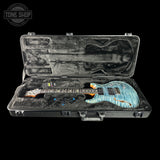 Guitar in an open case with 'Tone Shop' logo in the corner