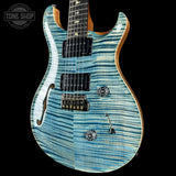 Blue electric guitar with a black background