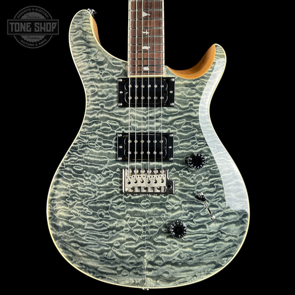 A double-cutaway electric guitar with a distinctive wavy, textured light gray and white flamed maple top, black hardware, and a dark brown fretboard, shown against a solid black background.