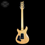 A natural wood electric guitar shown from the back against a solid black background, featuring a maple body, black pickguard, and a Tone Shop watermark in the top left corner.