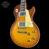 Electric guitar with a sunburst finish on a black background, featuring the Tone Shop logo.