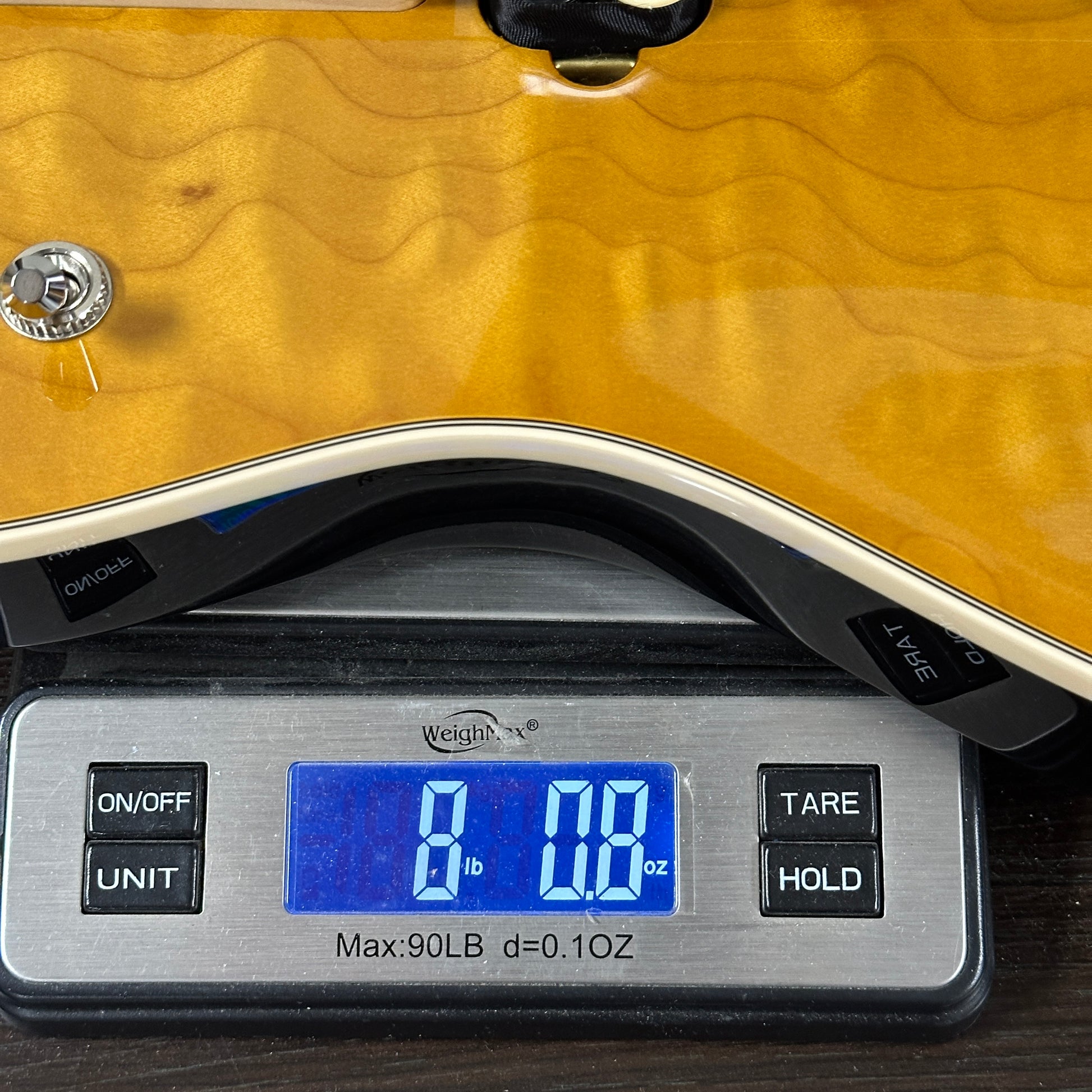 Digital scale displaying weight on a wooden surface