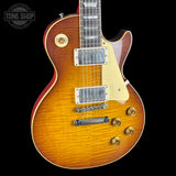 Electric guitar with a sunburst finish on a black background, featuring the Tone Shop logo.