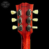 Close-up of a red guitar headstock with tuning pegs on a black background, featuring 'Tone Shop' branding.