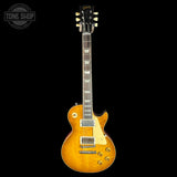 Electric guitar with a sunburst finish on a black background, featuring the Gibson logo.