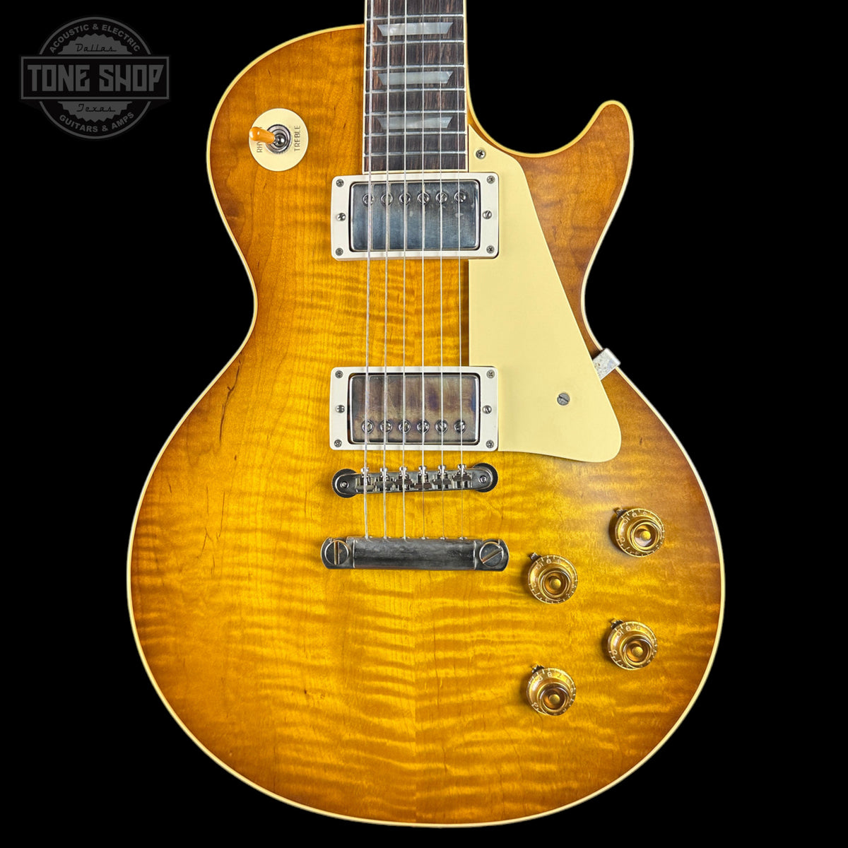 Electric guitar with a sunburst finish on a black background, featuring the Tone Shop logo.