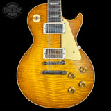 Electric guitar with a sunburst finish on a black background, featuring the Tone Shop logo.
