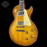 Electric guitar with a sunburst finish on a black background, featuring the Tone Shop logo.