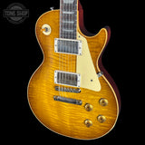 Electric guitar with a sunburst finish on a black background, featuring the Tone Shop logo.