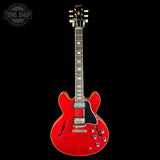 Red electric guitar on a black background with 'Tone Shop' logo.