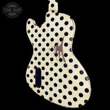 A double-cutaway electric guitar body with a distressed cream finish and black polka dots, shown against a solid black background. A Tone Shop watermark is visible in the top-left corner.