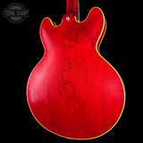 Red electric guitar body with a visible brand logo in the corner.