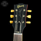 Gibson Les Paul guitar headstock with tuning pegs on a black background
