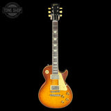 Electric guitar with a sunburst finish on a black background, featuring the Gibson logo.
