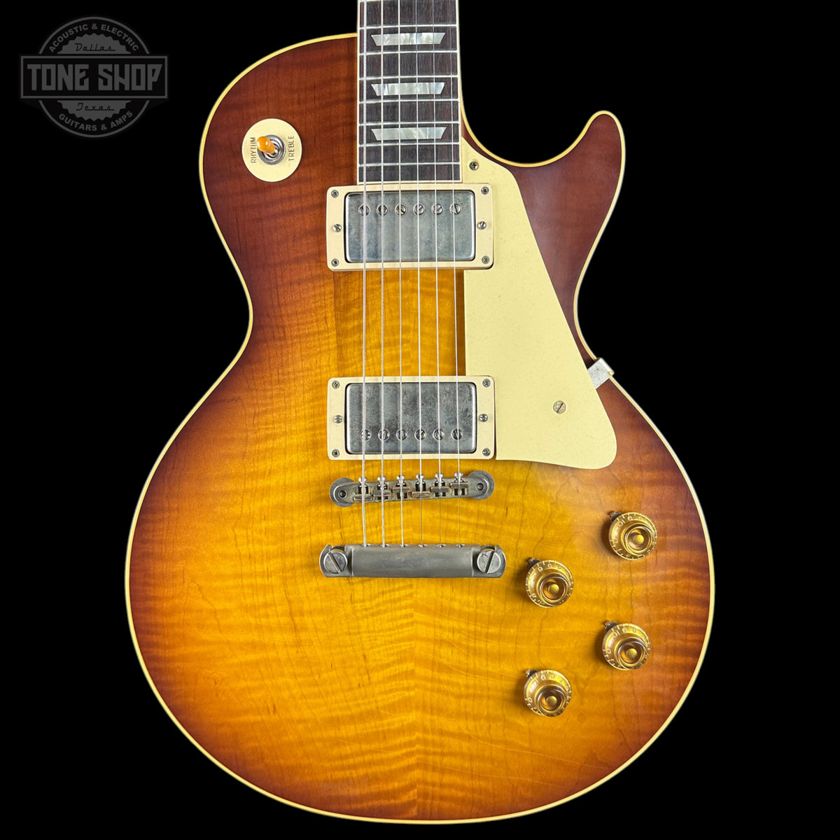 Electric guitar with a sunburst finish on a black background, featuring the Tone Shop logo.