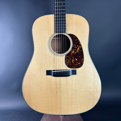 Acoustic guitar with a wooden finish on a dark background