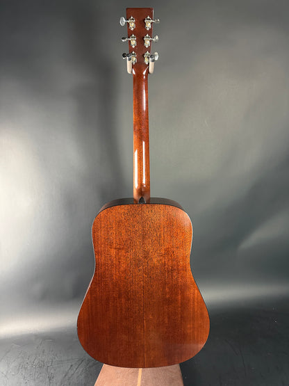 Wooden acoustic guitar on a gray background