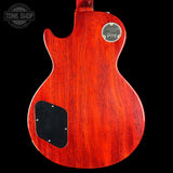 Red electric guitar body with a visible brand logo on a black background