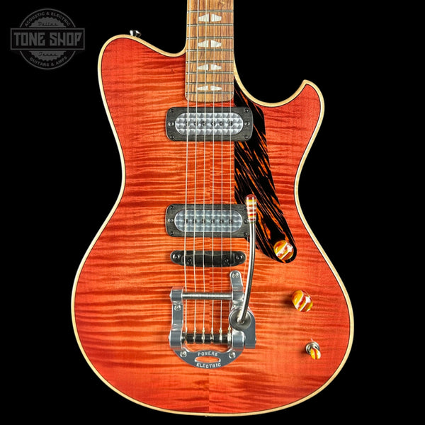 Electric guitar with a sunburst finish on a black background, featuring the Tone Shop logo.