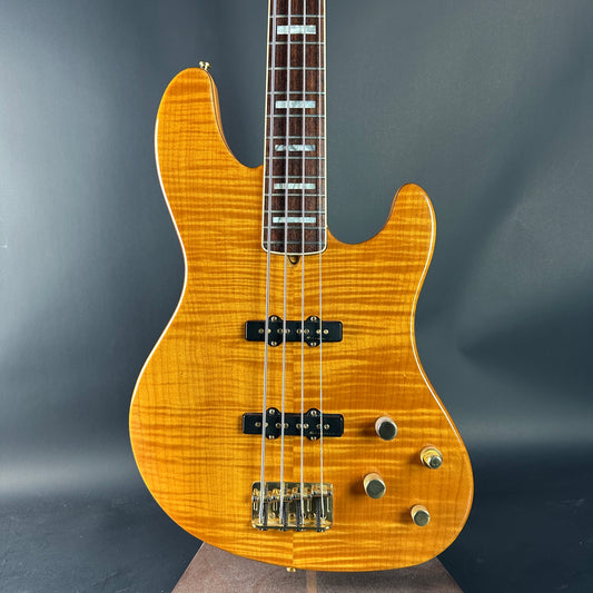 Electric bass guitar with a sunburst finish on a dark gray background