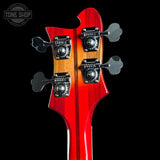 Close-up of a red electric guitar's headstock with tuning pegs on a black background, featuring 'Tone Shop' logo.