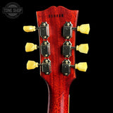 Close-up of a red guitar headstock with tuning pegs on a black background, featuring 'Tone Shop' branding.