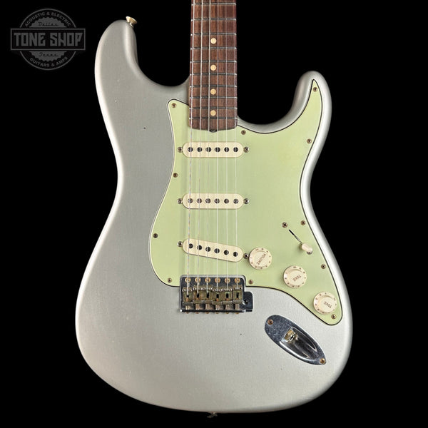 Silver electric guitar with a visible brand logo on a black background