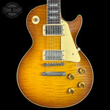Electric guitar with a sunburst finish on a black background, featuring the Tone Shop logo.