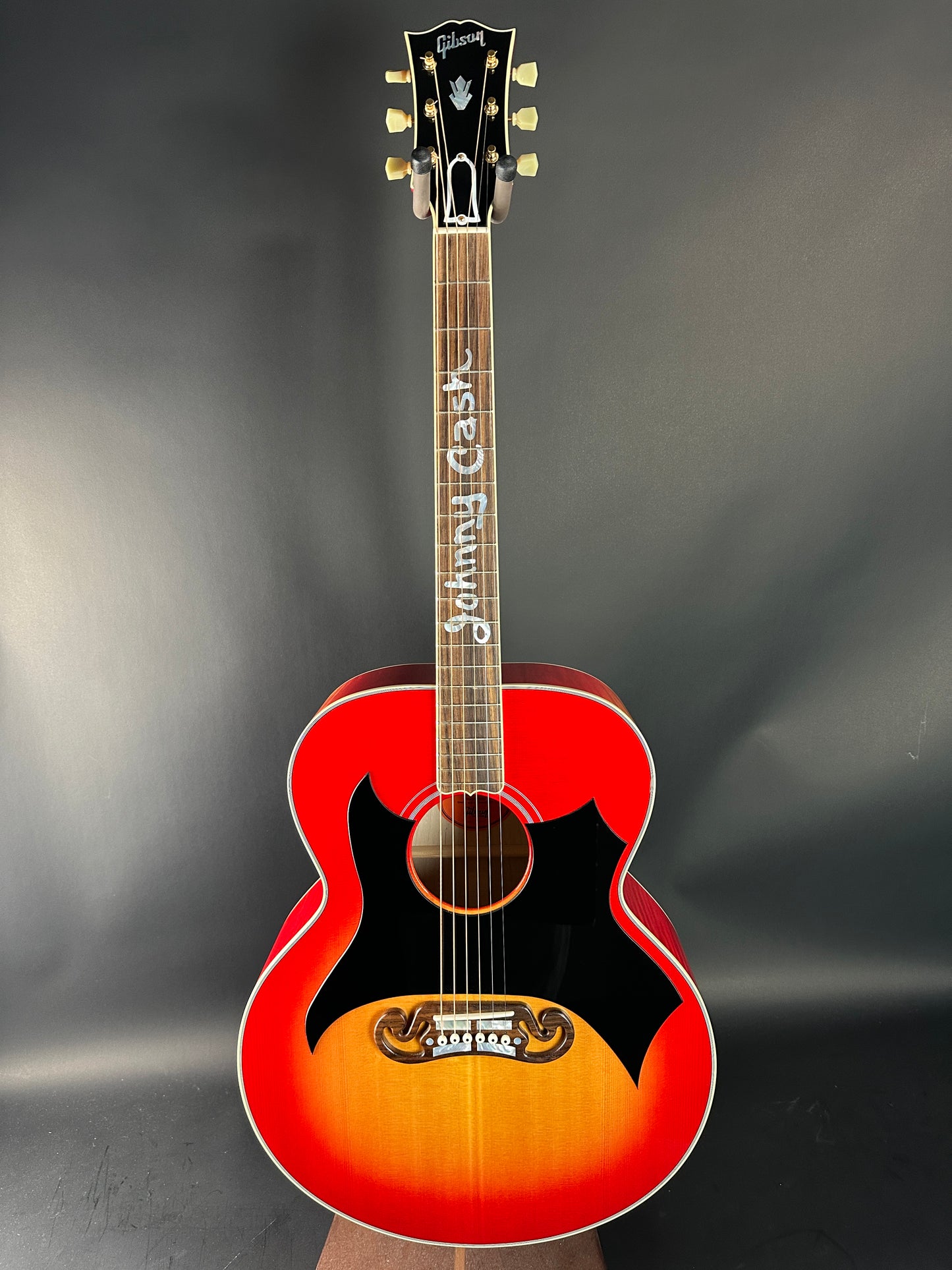 Acoustic guitar with a sunburst finish on a dark background