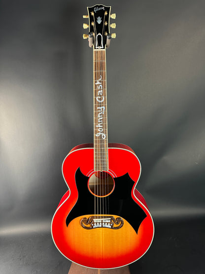 Acoustic guitar with a sunburst finish on a dark background