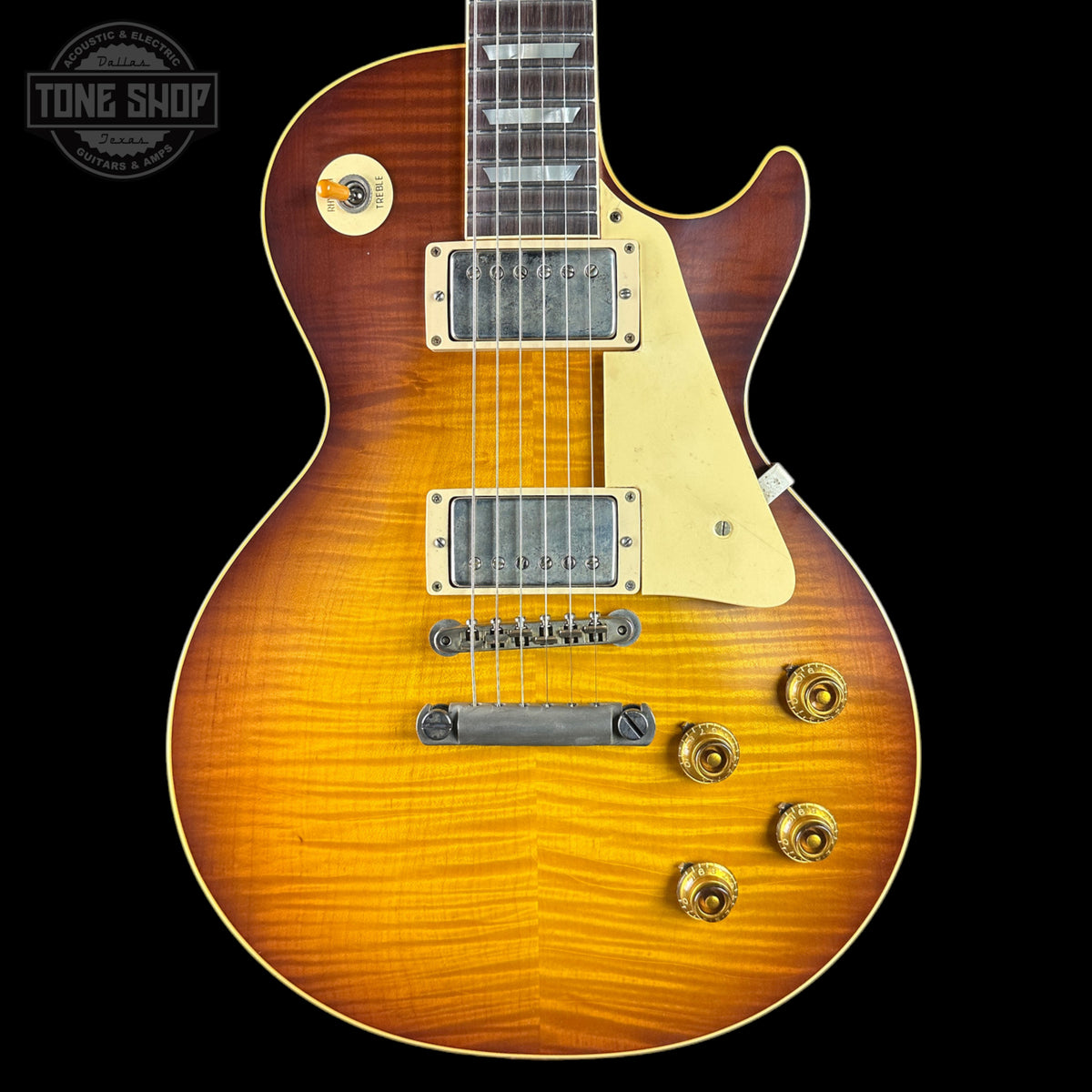 Electric guitar with a sunburst finish on a black background, featuring the Tone Shop logo.