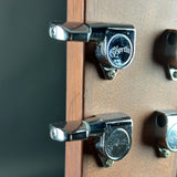 Close-up of Martin acoustic guitar tuning pegs mounted on a wooden headstock, with the Martin logo clearly visible on the metal hardware.