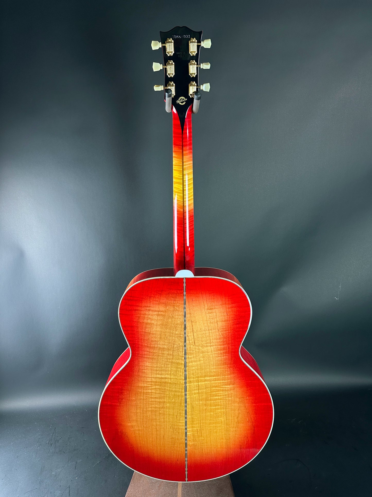 Acoustic guitar with a sunburst finish on a dark gray background