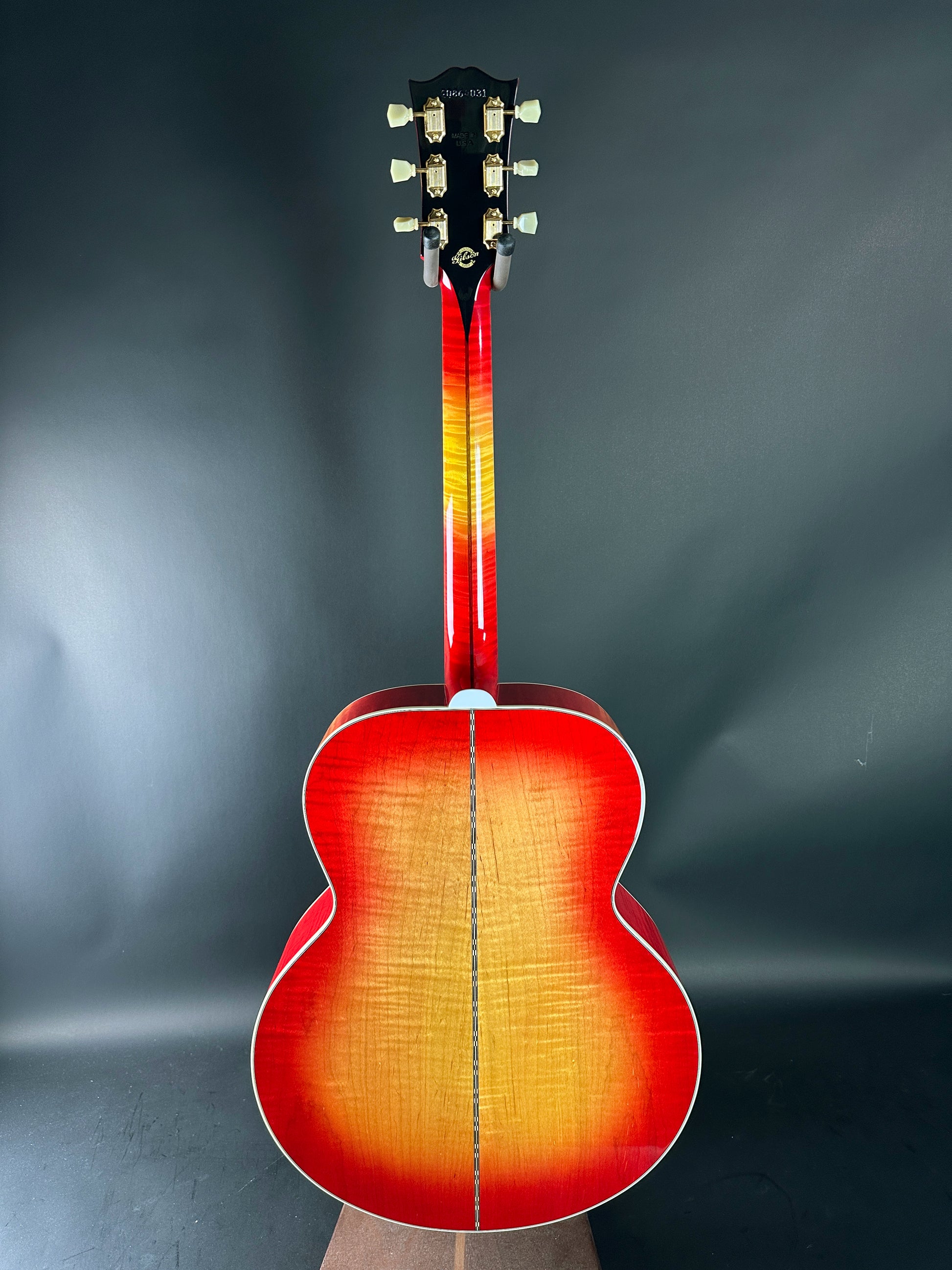 Acoustic guitar with a sunburst finish on a dark gray background