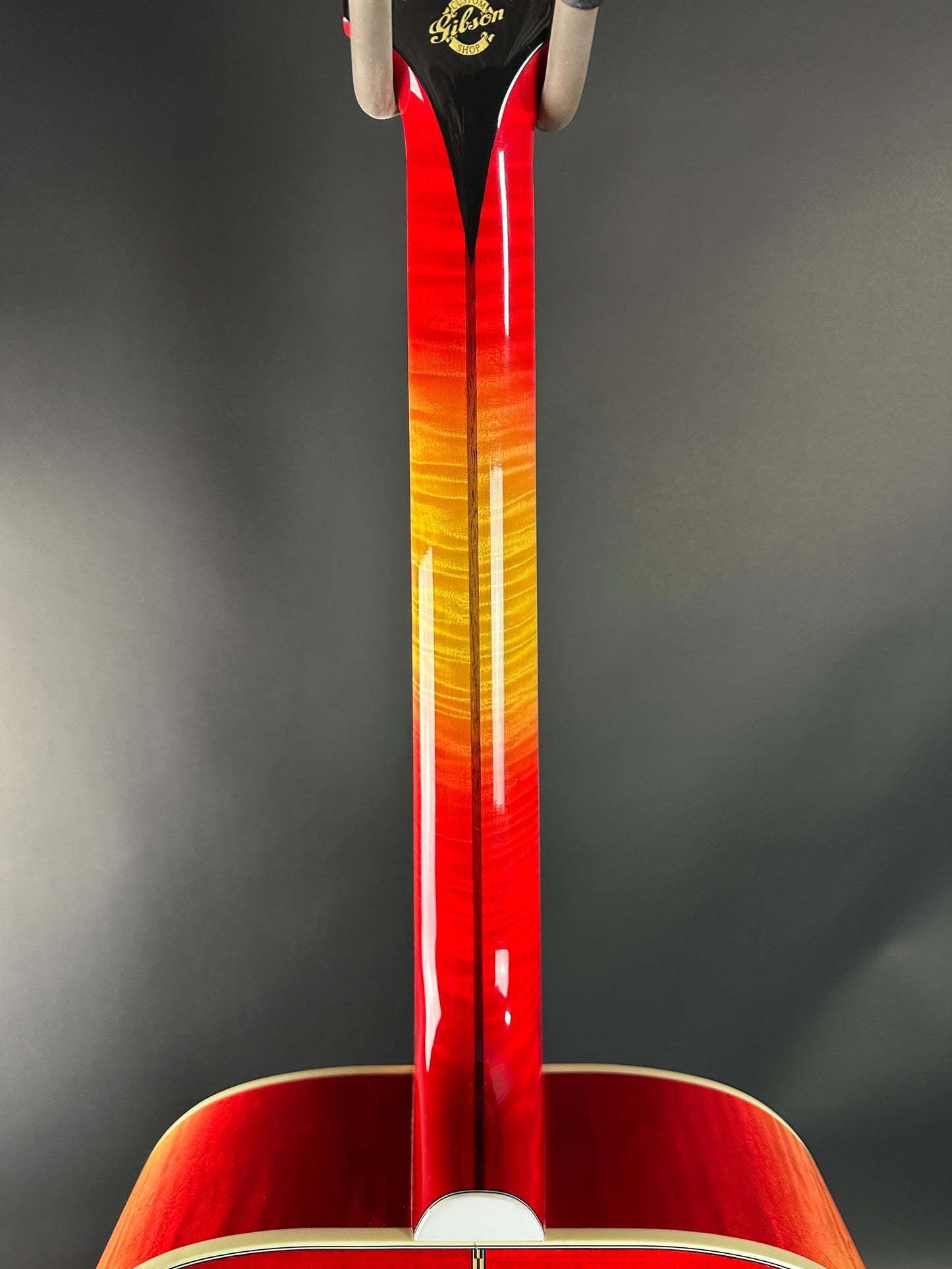 Red acoustic guitar on a dark gray background