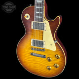 Electric guitar with a sunburst finish on a black background, featuring the Tone Shop logo.