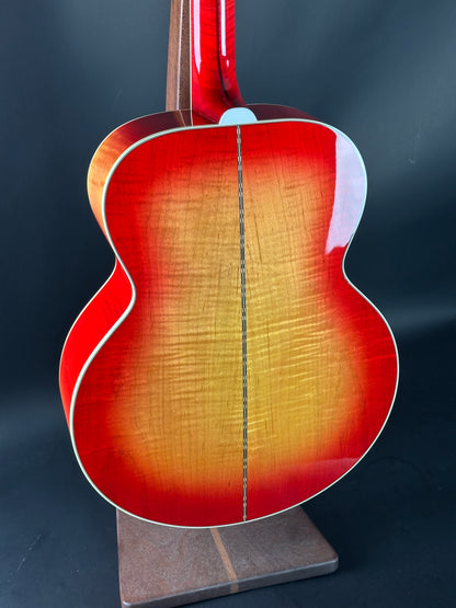 Close-up of a red acoustic guitar on a dark background