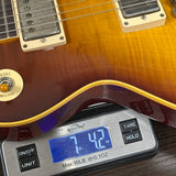 Guitar on a digital scale displaying weight